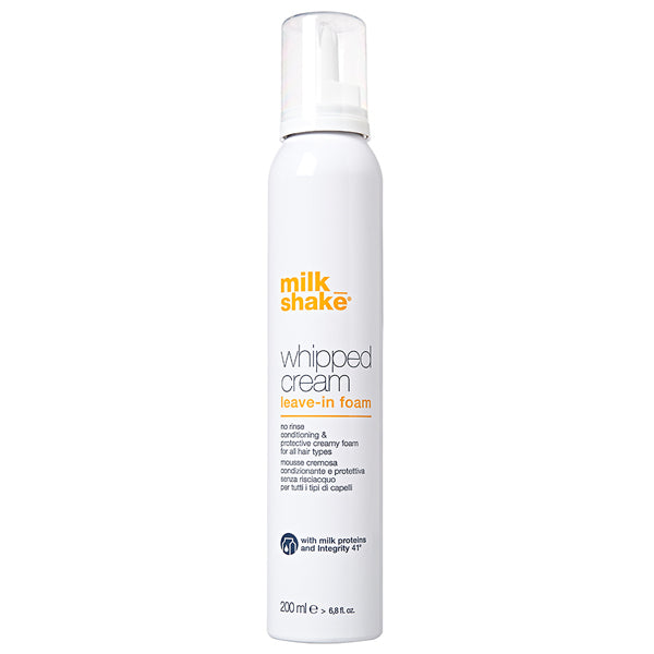 A white bottle of Milk_shake Whipped Cream leave-in foam with orange and grey text, shown against a plain white background.